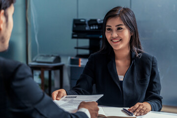 Human resource manager interviewing the male employment candidate in the office room. Happy job...