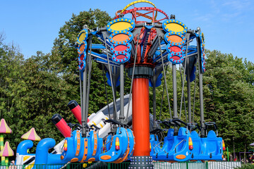 Colourful children playground with mixed plastic and metallic toys and materials in a sunny summer...