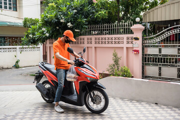 Deliveryman ride and park motorbike