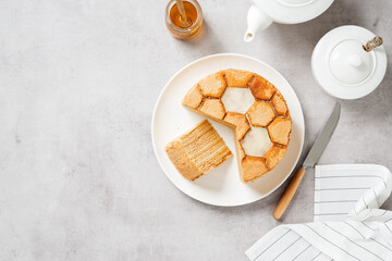 Layered honey cake Medovik. Traditional russian cuisine. Top view. Light gray background. Space for text 