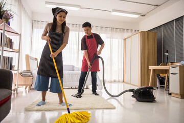 Young couple cleasing bedroom after moving
