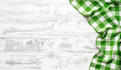 White wooden table covered with green tablecloth. View from top. Empty tablecloth for product montage. Free space for your text - 428533220