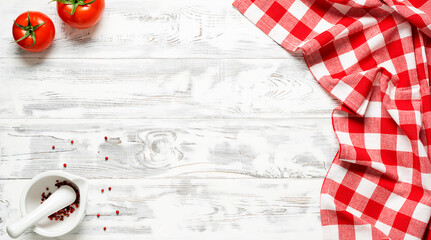 White wooden table covered with red tablecloth. View from top. Empty tablecloth for product...