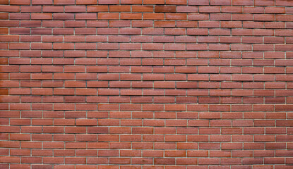 Fototapeta premium background of red brick wall texture. Home or office design backdrop texture of red brick wall.