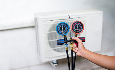 Technician is checking air conditioner.	