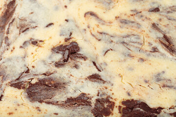 Obraz na płótnie Canvas Top view of a cheesy brownie with cheesecake.
