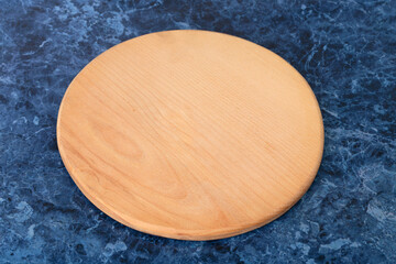 A cutting board is on a blue marble countertop.