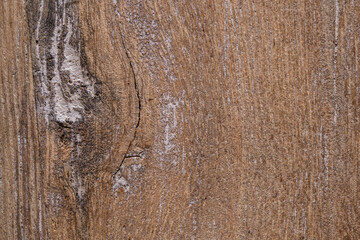 Fototapeta premium Closeup textured background of uneven rough brown lumber surface with dirty gray stains