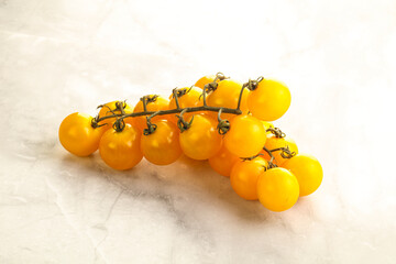 Branch with yellow cherry tomato