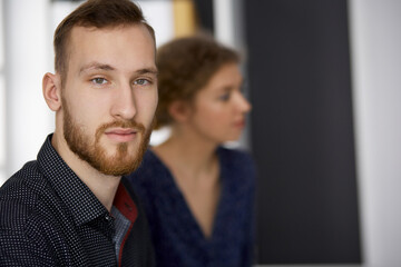 Bearded friendly adult businessman looking at camera. Business headshot or portrait in office