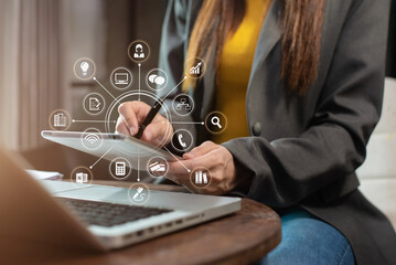 Businesswomen working with laptop and digital tablet computer in office with digital marketing media in virtual icon.