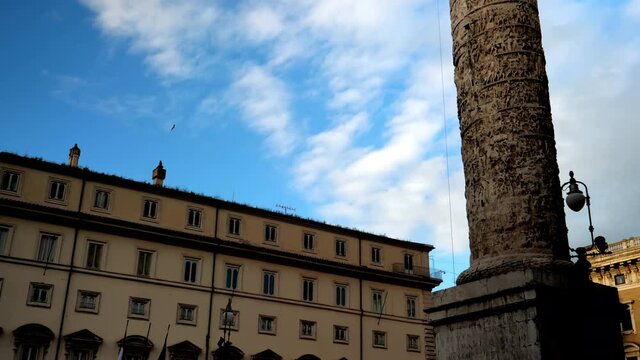 Vew of the column of Emperor Marcus Aurelius with a statue of the Apostle Paul on top in front of the palace Chigi, the location of Italian government