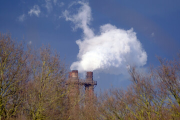Fototapeta na wymiar Steam and smoke emitting from steel making plant stack.