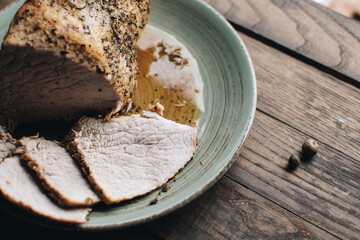 Roasted pork tenderloin, juicy and succulent oven-baked piece of meat rubbed with mustard and spices. A juicy piece of baked meat.