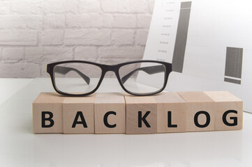 the word lag, written on cubes on a light office background with glasses and papers, business concept