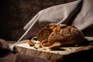 Bread and drying lie on a wooden board on a dark background