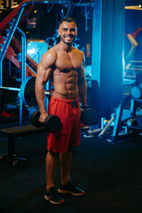 Obraz na płótnie Canvas a man with muscles at the gym