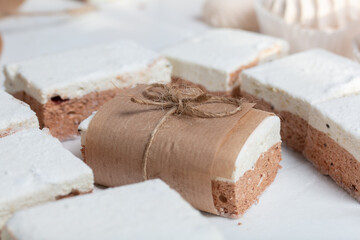 Portion marshmallow with cocoa and cranberries. Wrapped in paper and tied with string. Two-layer...