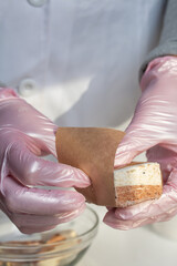 A woman is packing homemade marshmallows. Cooking marshmallows at home.