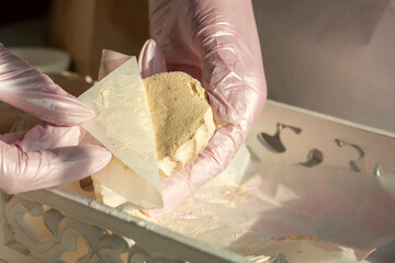 A woman is packing homemade marshmallows. Cooking marshmallows at home.