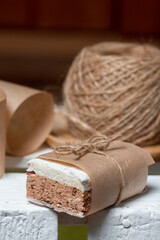Portion marshmallow with cocoa and cranberries. Wrapped in paper and tied with string. Two-layer zephyr.