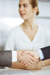 Fototapeta na wymiar Business people shaking hands finishing contract signing, close-up. Business communication concept. Handshake and marketing
