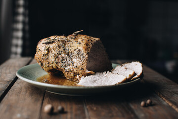 Roasted pork tenderloin, juicy and succulent oven-baked piece of meat rubbed with mustard and spices. A juicy piece of baked meat.