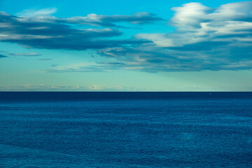 Obraz premium View to the sea and blue cloudy sky