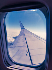 Flight in an airplane, view from the window on the wing of an airplane, the concept of resuming international transportation