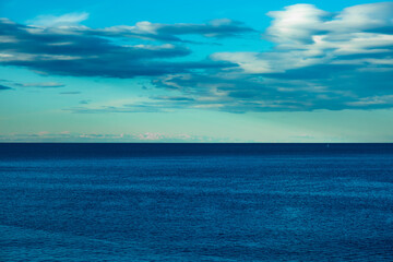 Naklejka na ściany i meble View to the sea and blue cloudy sky