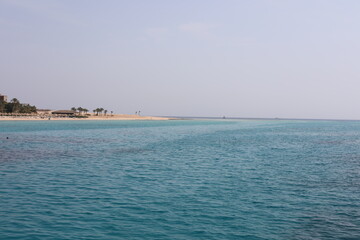 Obraz premium Clear waves on the beach. Beauty of beach in the morning. Blue water ripples. Wonderful swim in clean turquoise sea water. Scenic backdrop of beautiful transparent water of the Red Sea with sun shine