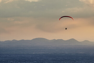 Paraglider in the sky at sunset