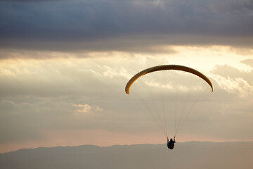 Paraglider silhouette at sunset