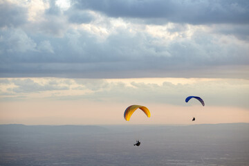 Paragliding in the sky at sunset