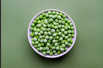Fresh frozen peas in white bowl. with copy space