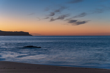 Sunrise seascape with scattered high cloud