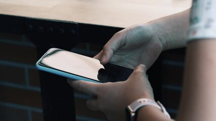 Hand of girl using smartphone in the living room at coffee shop, communication and chatting on social online. Close up using mobile smart phone. (4k Smiling businessman) - Powered by Adobe