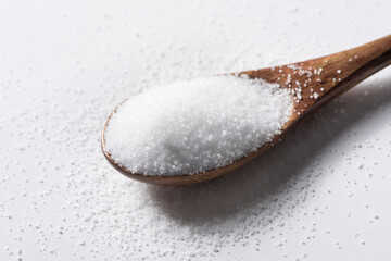 heap of salt close up in wood spoon background