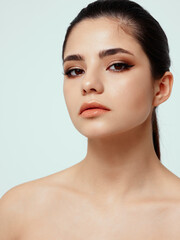 beautiful woman with bare shoulders and makeup on face cosmetology dermatology