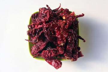 Byadgi Red Dry Chili or Bedgi Mirch, Lal Mirchi on white background. It is a famous variety of...