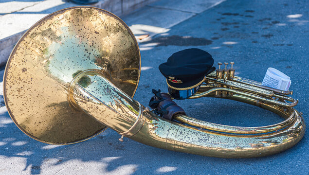 Tuba sousaphone of a brass band musician resting on the ground during a break