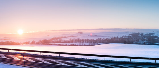 Winter landscape, sunset over the hills near the national road.