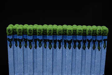 Fototapeta premium blue matchsticks with faces painted on the heads