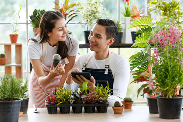 Modern men women gardeners close together talking sale trees on social media. In a glass room...