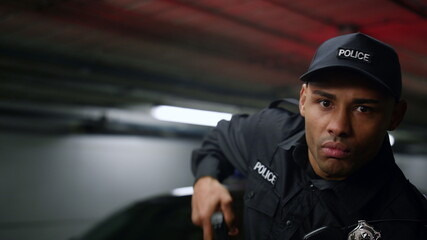 Policeman aiming target with gun. Police officer holding weapon in hands