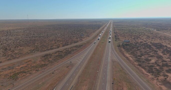Desert road aerial of a new two of long lane road through surrounded by desert landscape near San Jon New Mexico USA
