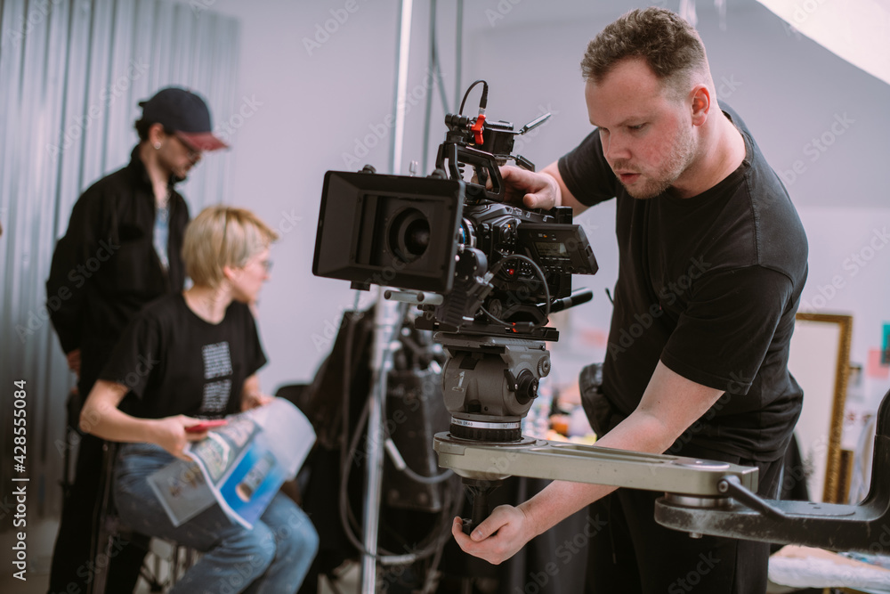 Wall mural Director of photography with a camera in his hands on the set.