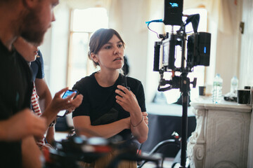 Director at work on the set. The director works with a group or with a playback while filming a...