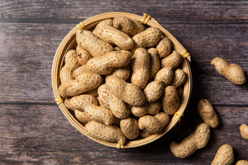 Raw fresh peanuts on wood background
