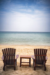 Beach chair under coconut tree looking away to sea view. Praw Bay, Samed,Thailand.